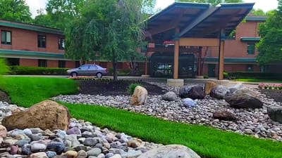 Exterior view of the assisted living facility entrance and garden area