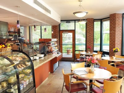 Bright dining area with tables and pastries