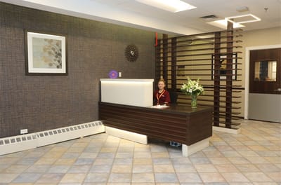 Reception area with staff member and flowers