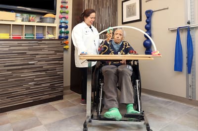 Therapist assisting an elderly resident in therapy