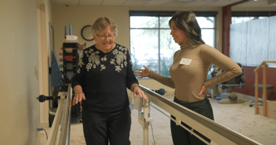 Staff assisting a resident in a therapy session