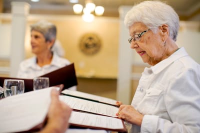 Residents reading menus in a dining room