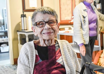 Smiling resident in a cozy indoor setting