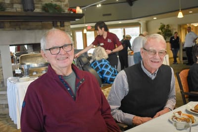 Two residents enjoying a meal in the dining area