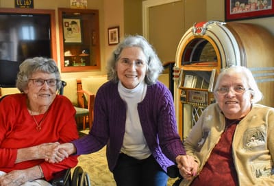 Residents and staff interacting in a cozy common area