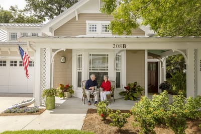 Two residents enjoying conversation on a porch