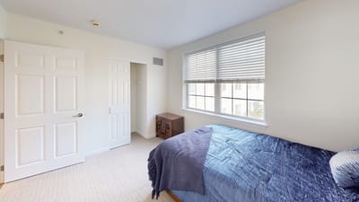 Bright private resident room with a bed and closet