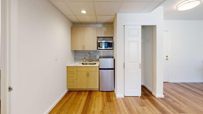 A well-furnished kitchenette in a resident unit