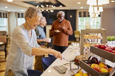 Residents enjoying snacks in a bright dining room