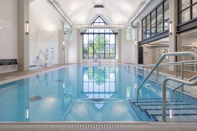Indoor pool area with natural light and modern design
