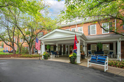 Front exterior of a senior living facility with outdoor seating