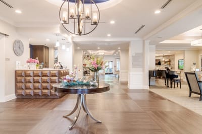 Bright interior common area with residents and decor