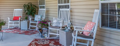 Outdoor seating area with rocking chairs and plants