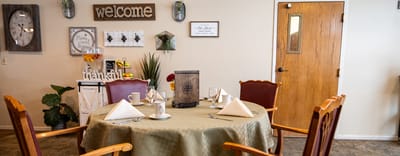 A dining room set up with a welcome sign