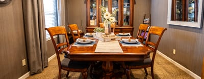 Dining area set up for a meal with floral centerpiece