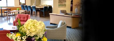 Bright common area with seating and flowers