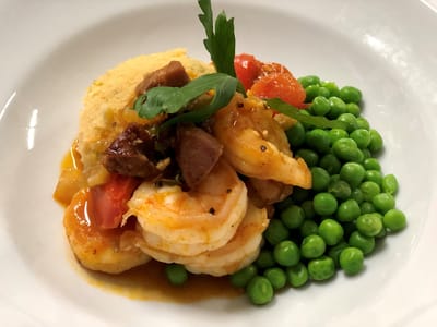 Plated meal of shrimp, vegetables, and peas