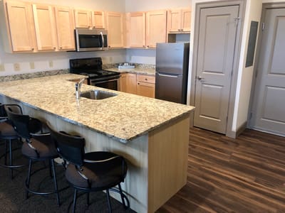 Modern kitchen interior with granite countertops and appliances