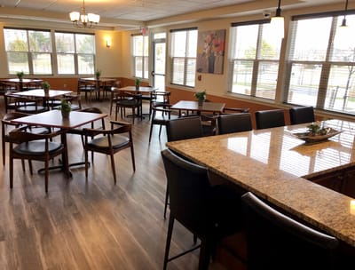 Interior view of a dining room with tables and chairs