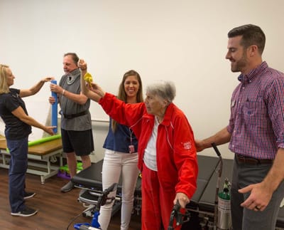 Residents and staff engaged in a therapy session.