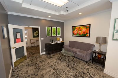 Lounge area with seating and floral artwork.