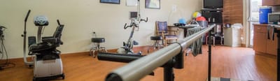 Interior rehabilitation space with exercise equipment.