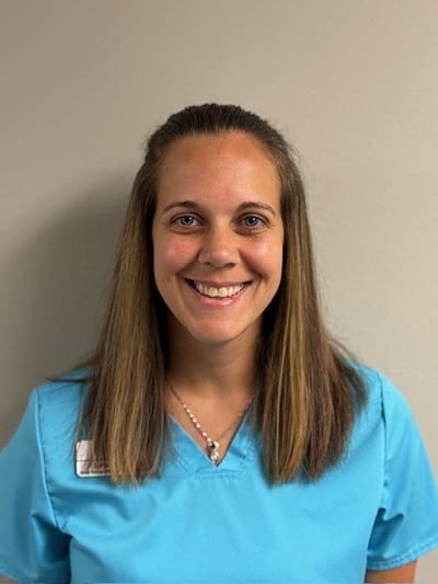 Staff member smiling in a facility setting