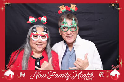 Two individuals in festive glasses and hats.