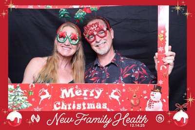 Two people in festive glasses at a Christmas event.