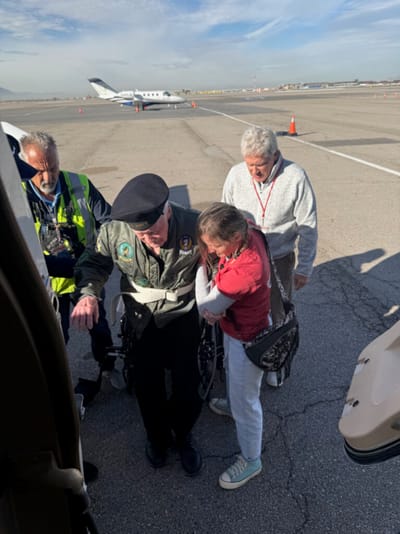 Veterans assisted by staff at an airport