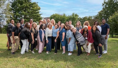 Group of smiling staff members in a park