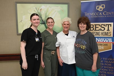 Staff members smiling together at an event