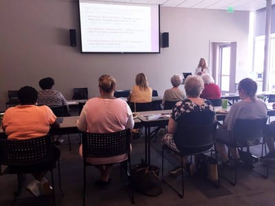 Residents attending a wellness workshop in a bright room.