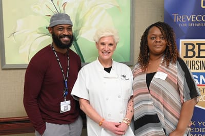 Staff members posing in a common area
