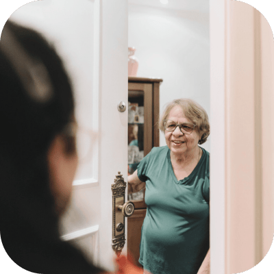 Resident greeting a visitor at the door.
