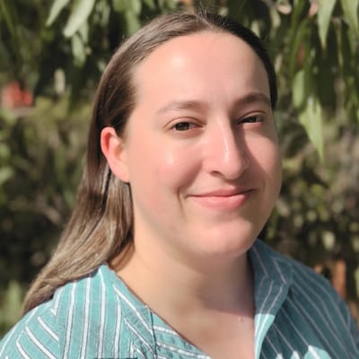 Smiling staff member outdoors in a garden