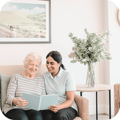 A caregiver reading with a senior resident