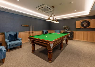 Game room with billiards table and lounge seating.
