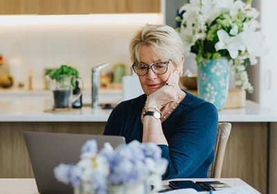 Senior woman using a laptop in a bright interior