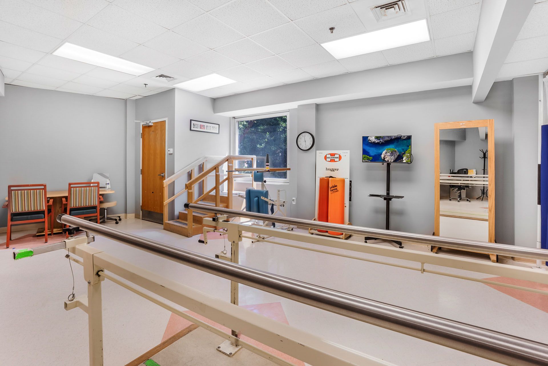 Rehabilitation area with therapy equipment and no people.