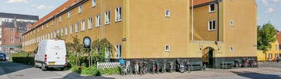 Exterior view of Nybodergården with bicycles and van.