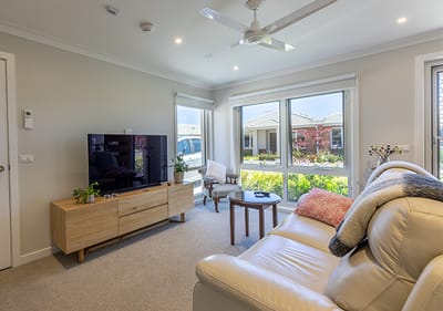 Cozy living room with natural light and comfortable seating.