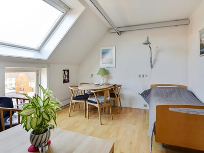 Cozy resident room with furniture and natural light.