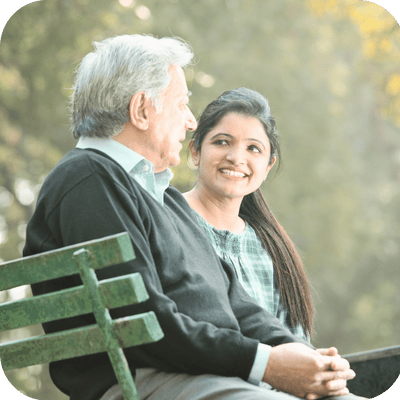 Senior man and woman enjoying a conversation outdoors.