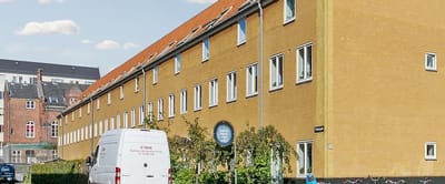 Exterior view of the facility building with a van