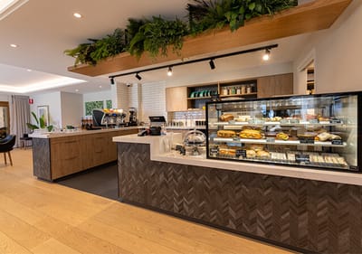 Interior view of a café area with food display.