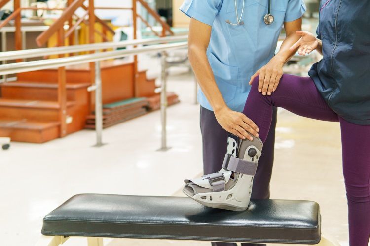 Healthcare professional assisting a patient with a leg brace