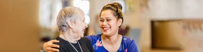 Senior resident enjoying time with staff member.