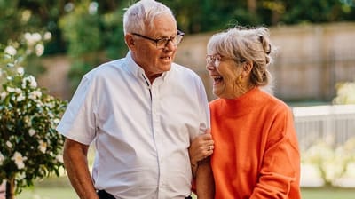 Two smiling seniors enjoying a moment together.
