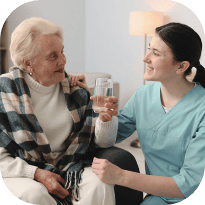 Nurse assisting a resident with a drink